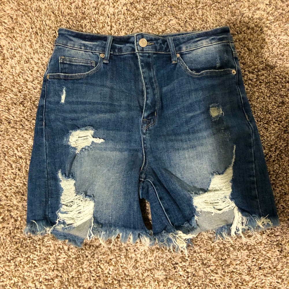 A pair of ripped jean shorts.
